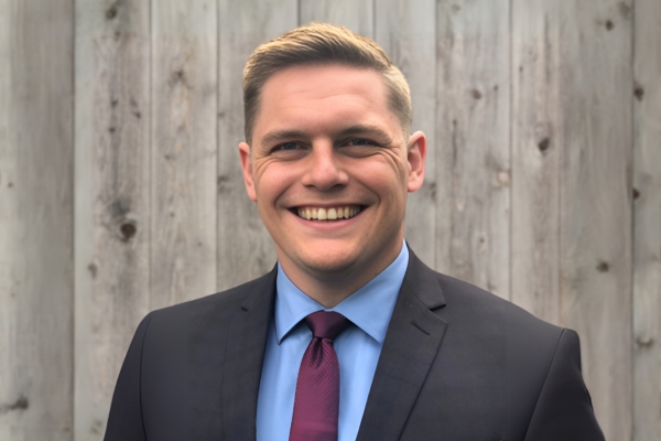 a man in a suit smiling