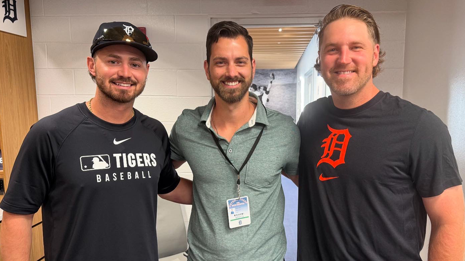 Three men pose for a picture.
